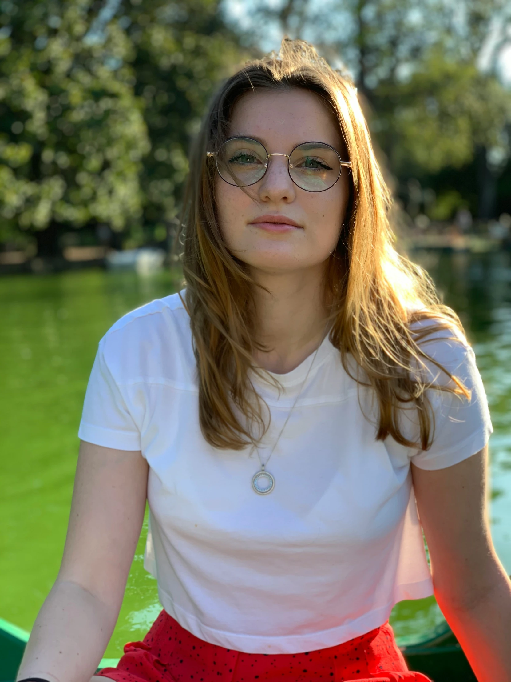 the girl in a white shirt is sitting on a boat