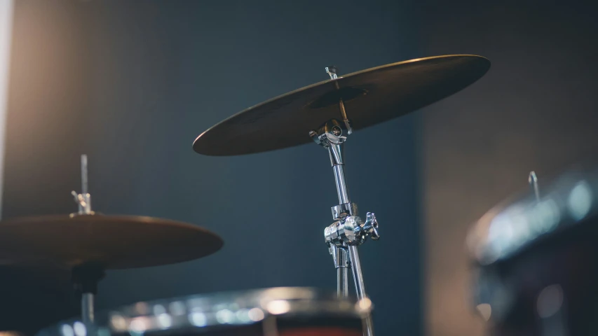 two drum set up with a wall in the background