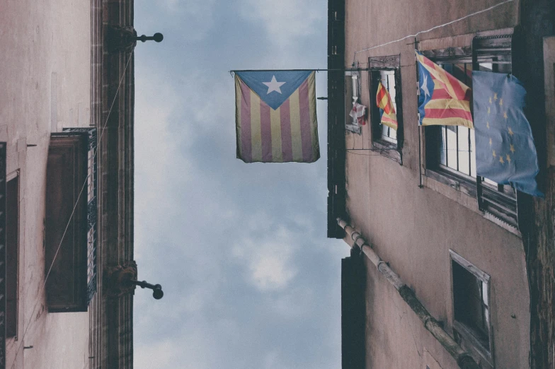 flags are seen flying in an alleyway