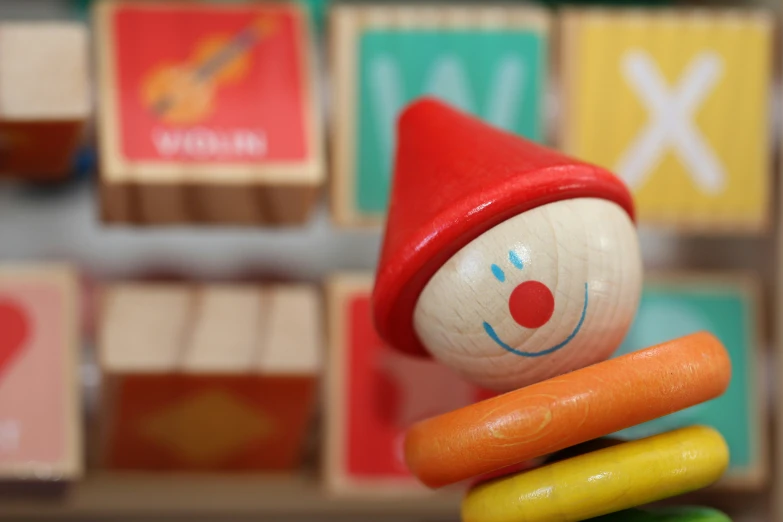 small wooden toys on top of each other in a display case