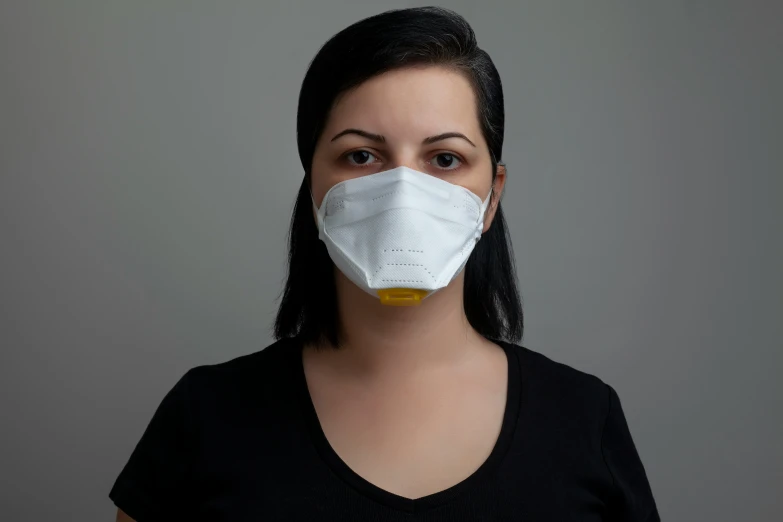 a person wearing a face mask to protect them from pollution