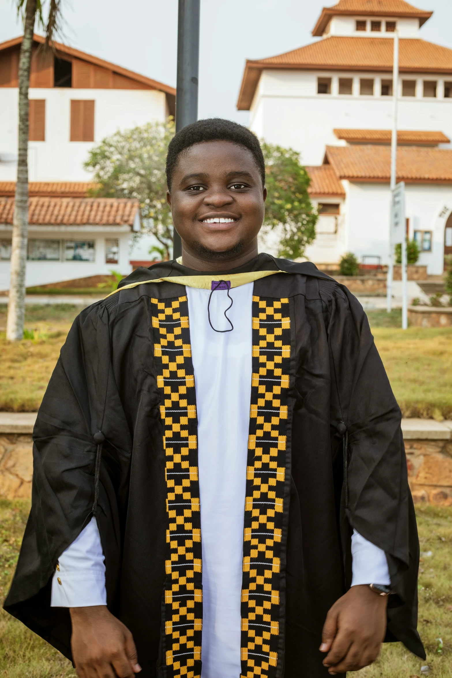 a black guy wearing a colorful graduation stole