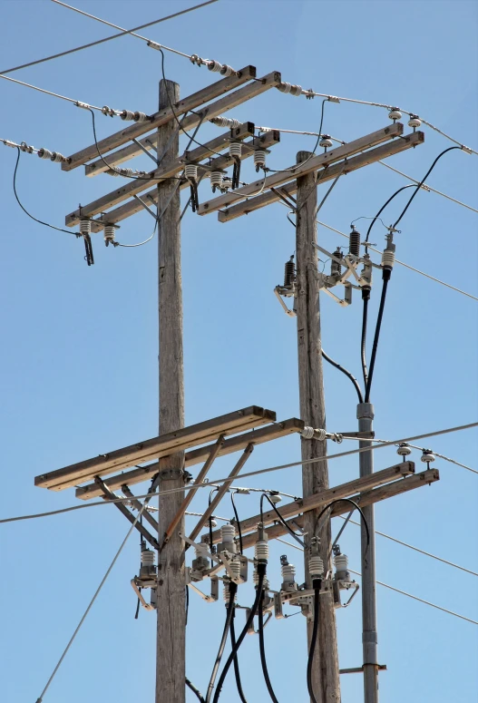 a high voltage electric pole in a blue sky