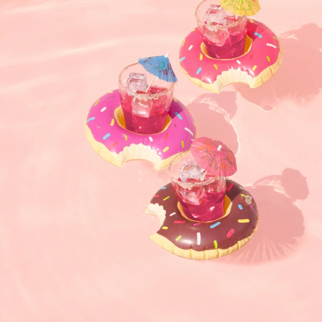 two inflatable donuts shaped like drink glasses on top of each other