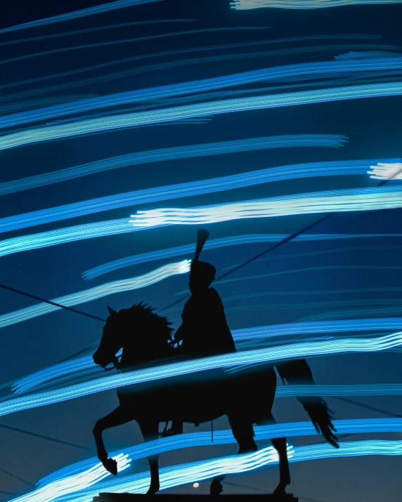 a silhouette of a man riding on the back of a horse in front of a lot of lights
