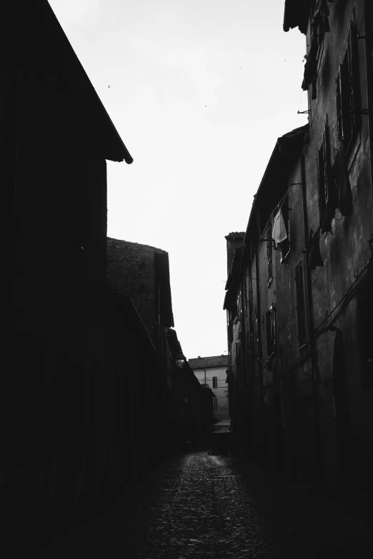 an old alley with cobblestone stones in black and white