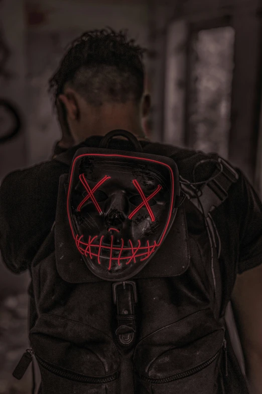 a man wearing a backpack with red neon on it