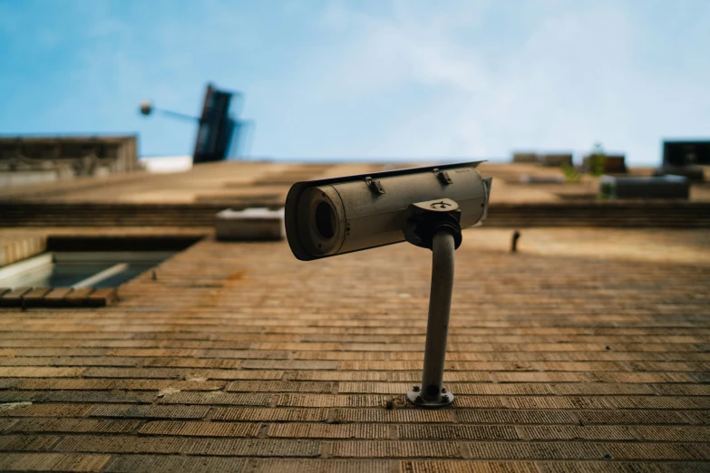 a security camera sitting on top of a brick roof