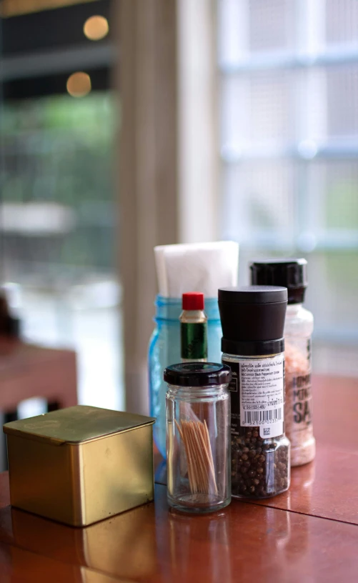 spices are placed on the counter in front of a metal container