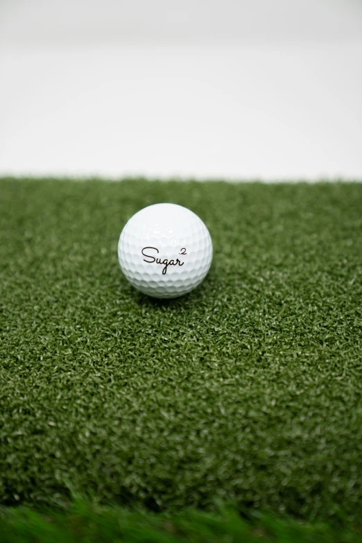 a golf ball sitting on top of a green field