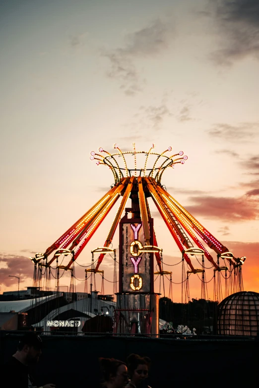 a big colorful carnival ride sitting in the middle of a night sky