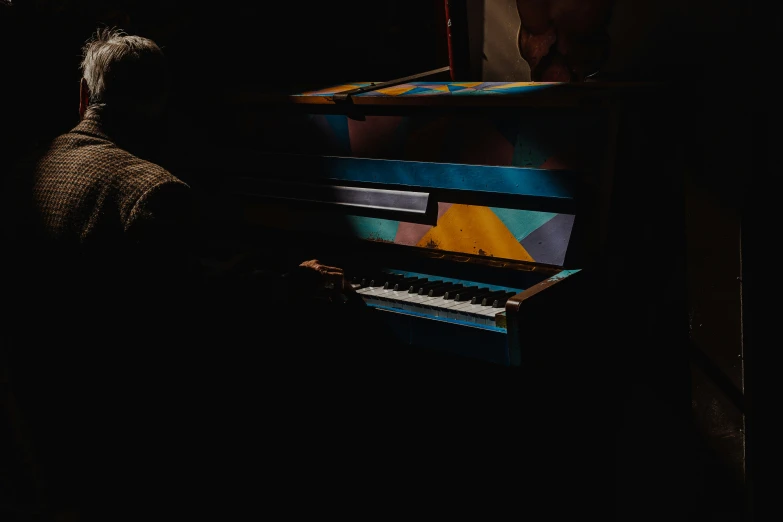 a person that is playing a piano in the dark