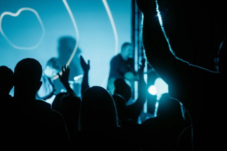 people standing around watching soing on a big screen