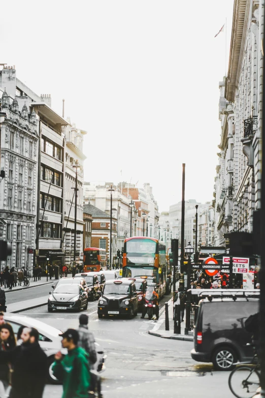 people are crossing the street in a busy city