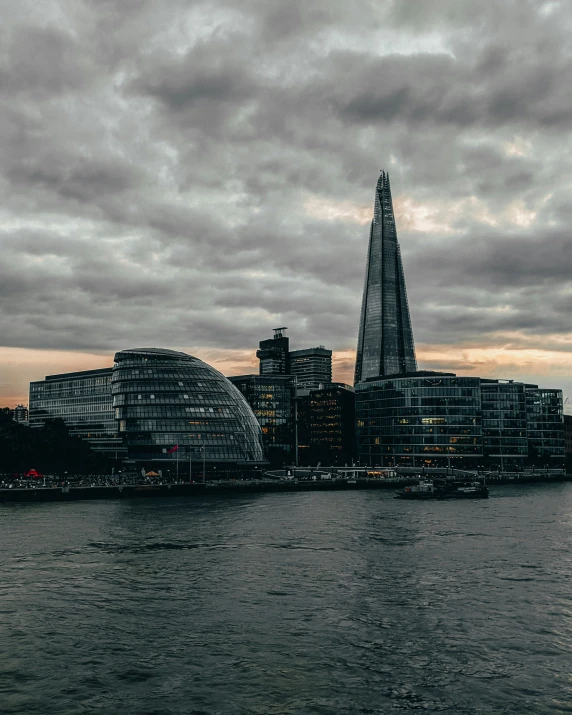 the shardle tower stands over the city on the water