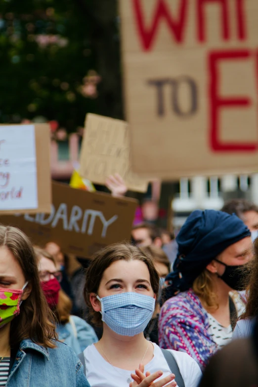 a group of people are standing with masks on