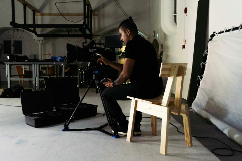 a man sitting in a chair with a camera