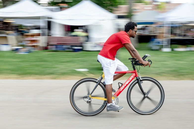 a man riding a bike down a street