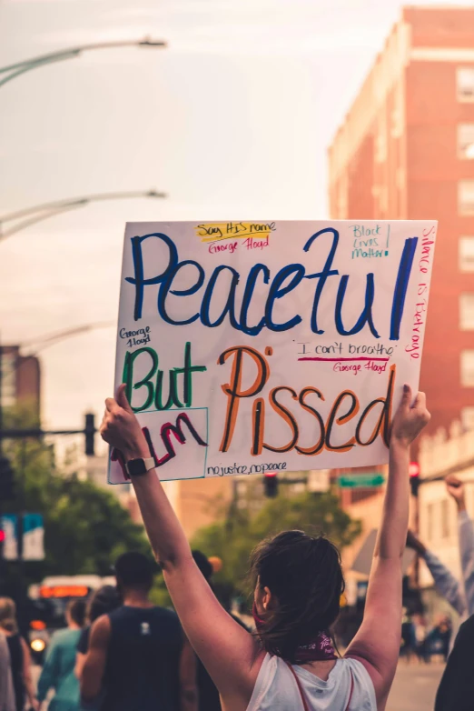 a person holding a sign that says peaceful but i'm pressed