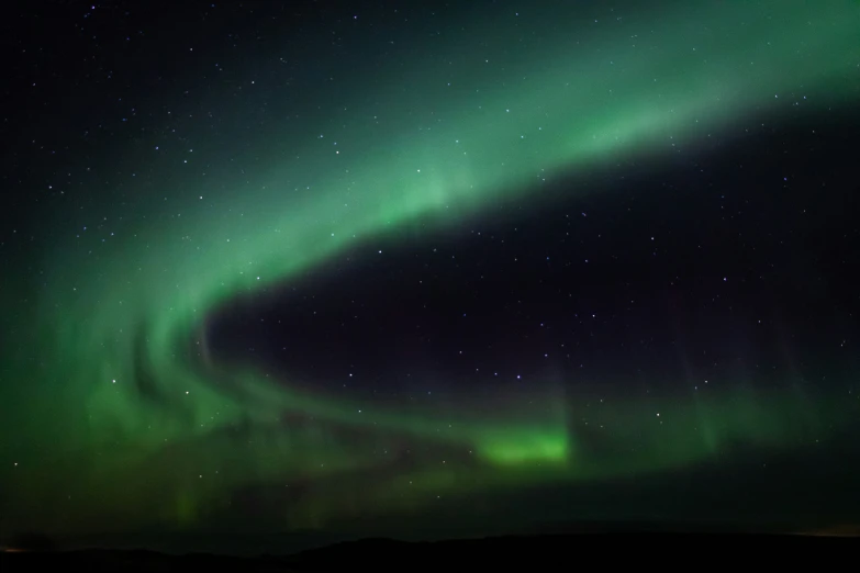 green and black aurora bored light shows on the side of the sky