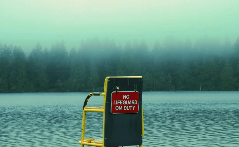 a lifeguard stand with an orange step up above water