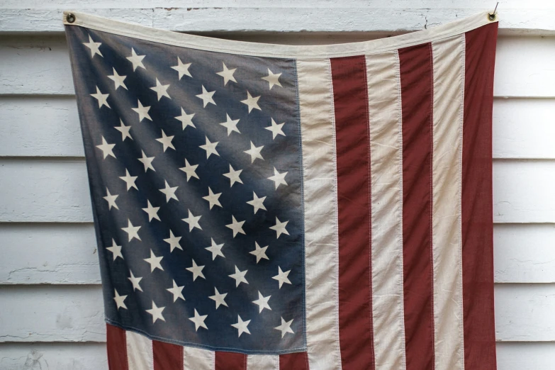 a large american flag dd over a white house