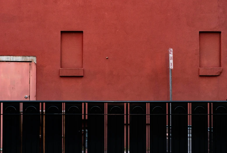 a red building that has two windows on it