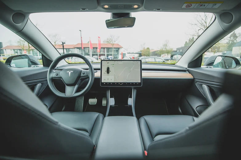 a car dashboard with a laptop on top of it