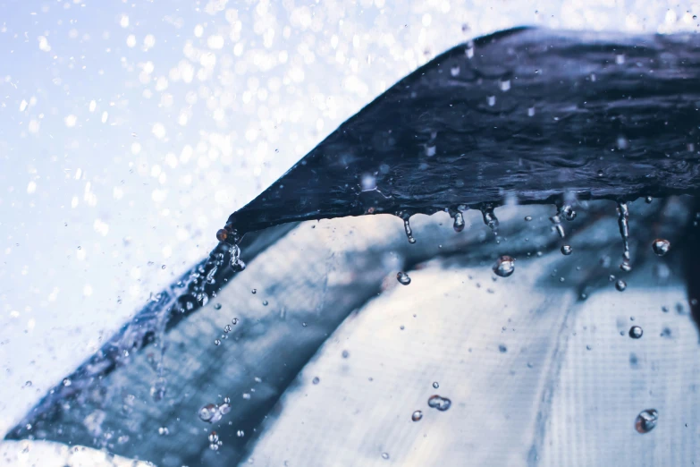 water falling on a umbrella in the rain