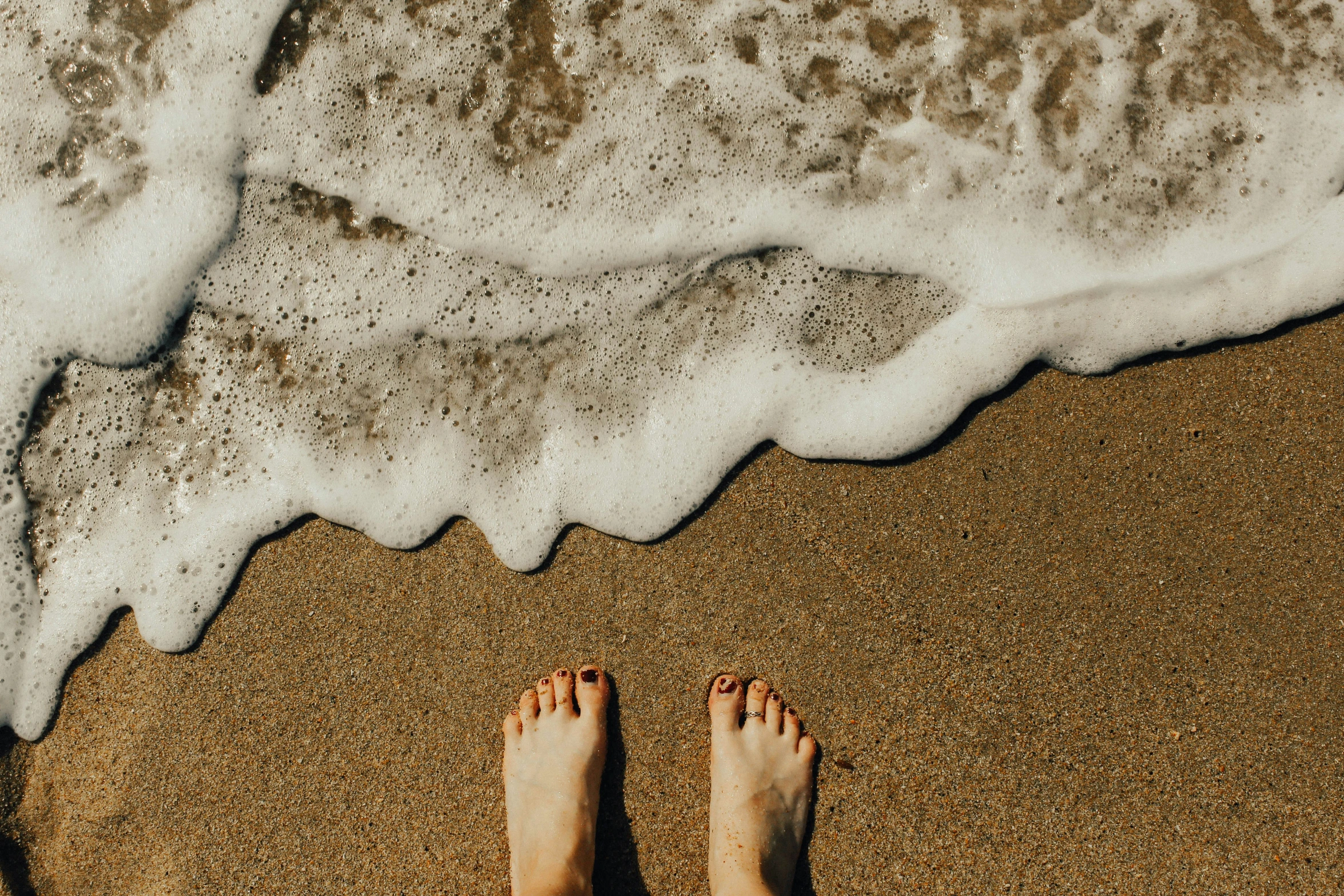 a person standing at the beach in front of the ocean