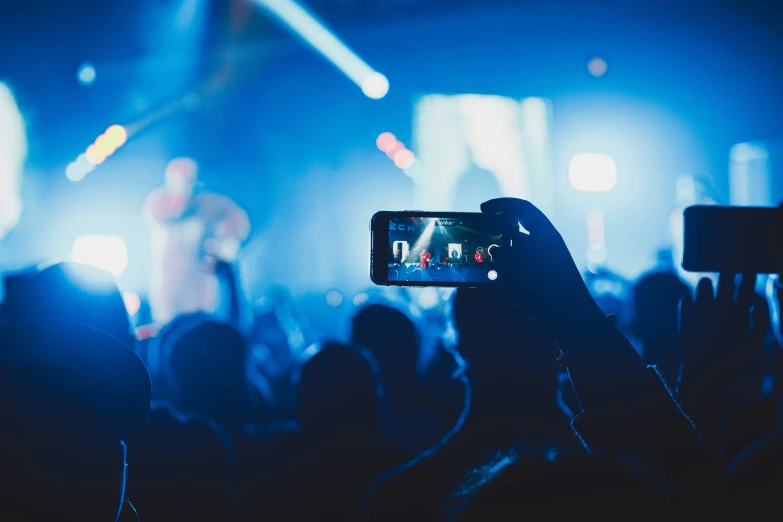 audience using smart phone to take video