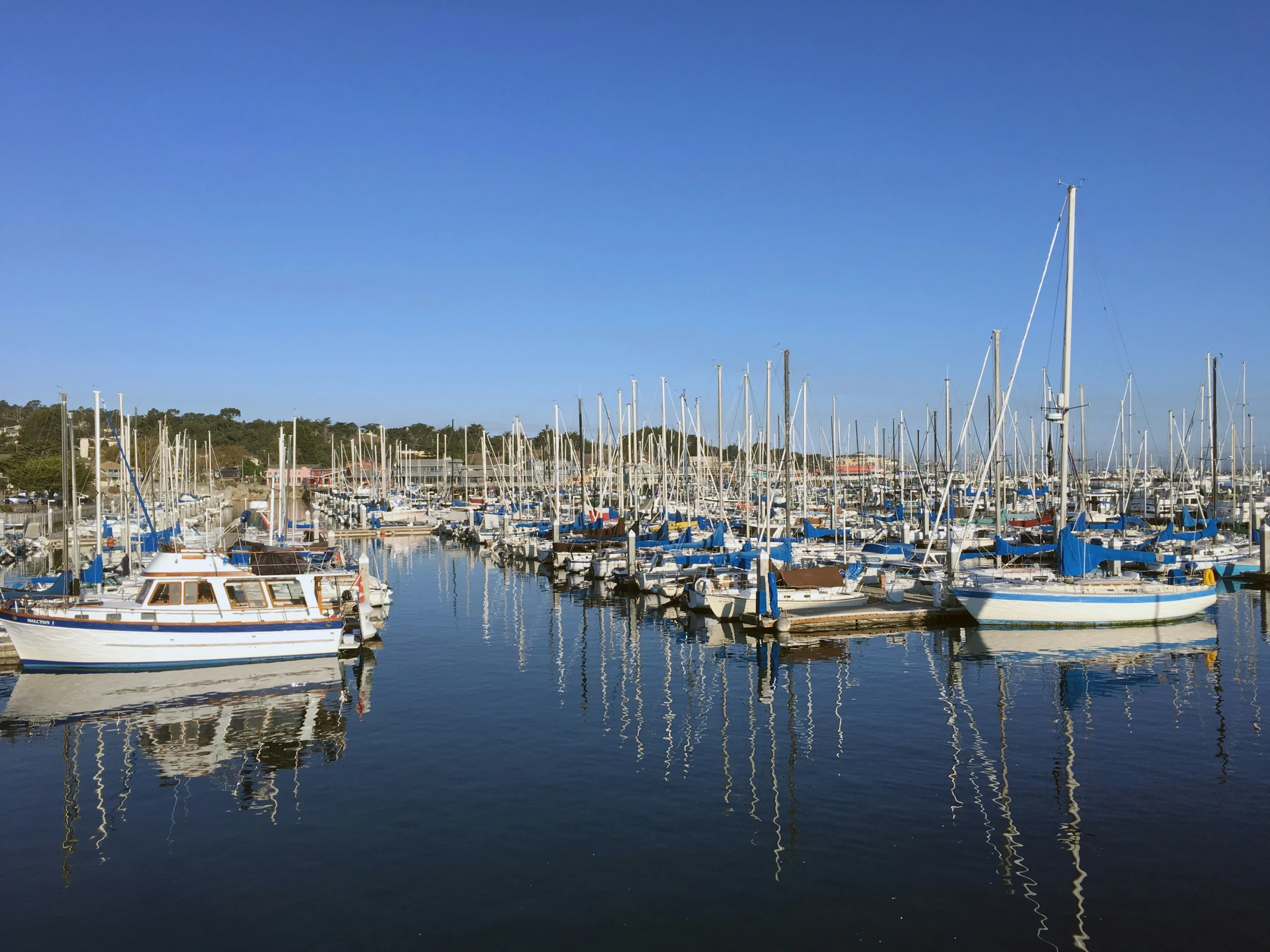 several small boats in the water with the sky in the background