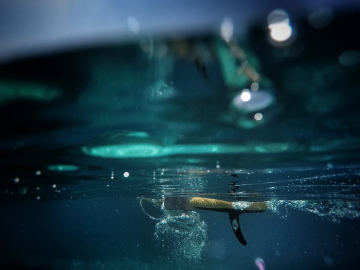 a cigarette floating in the water by itself