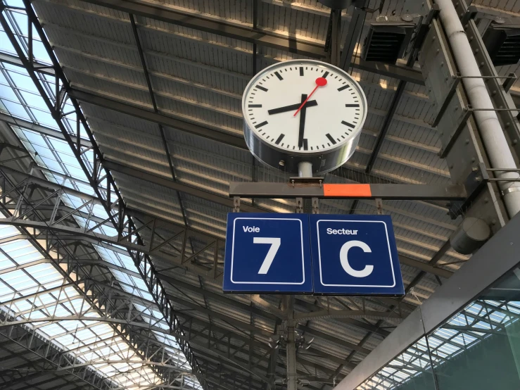 a clock and weather vane in an indoor station