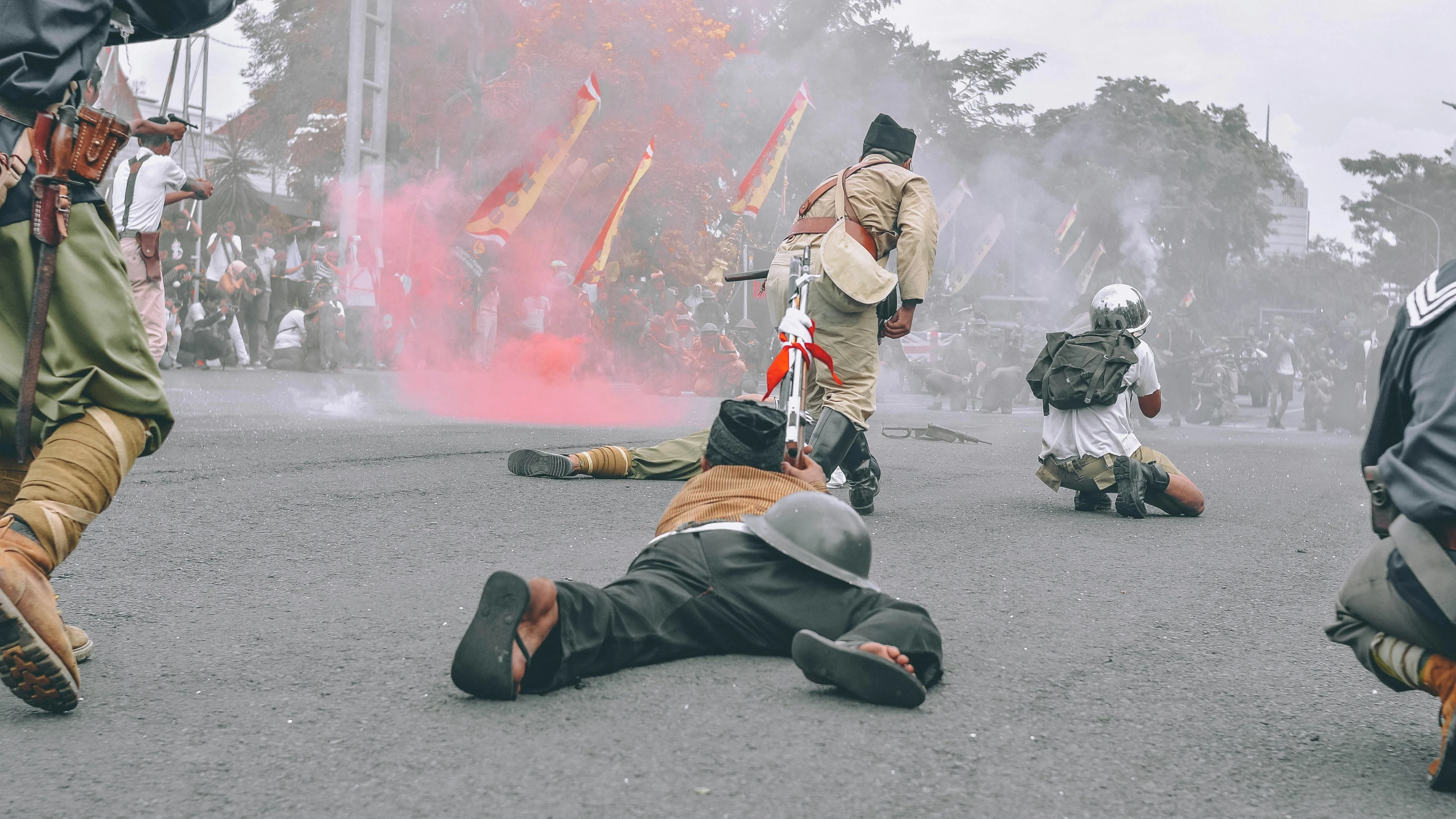 soldiers on the ground with their arms around one another