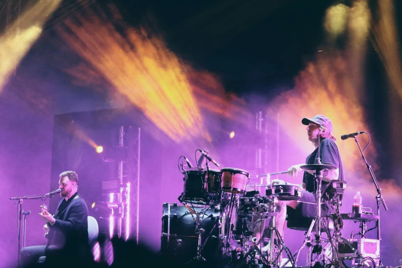 the band is playing a concert with a purple light