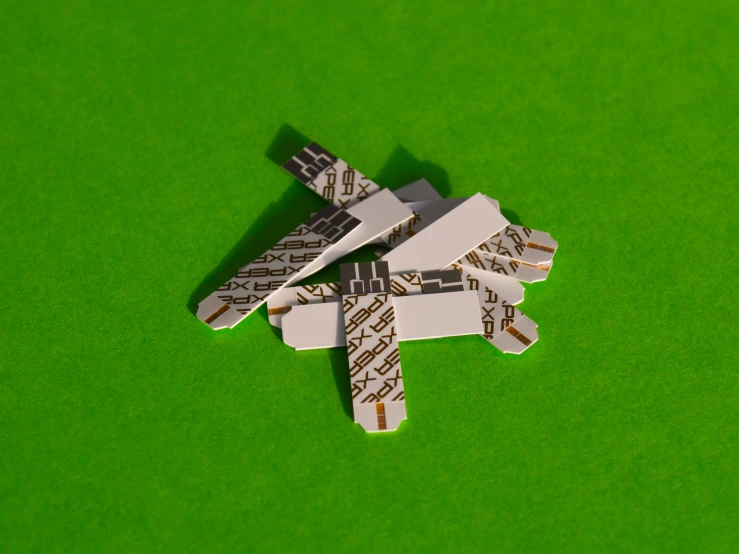 a piece of small metal airplane parts on green paper