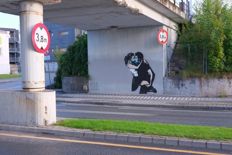 a mural on the side of a building, depicts a man carrying a child