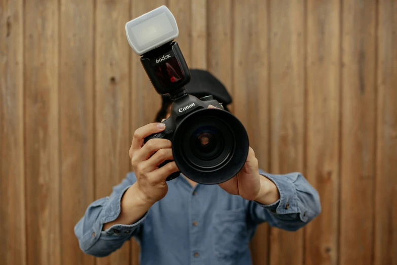 a man with a camera on top of his face