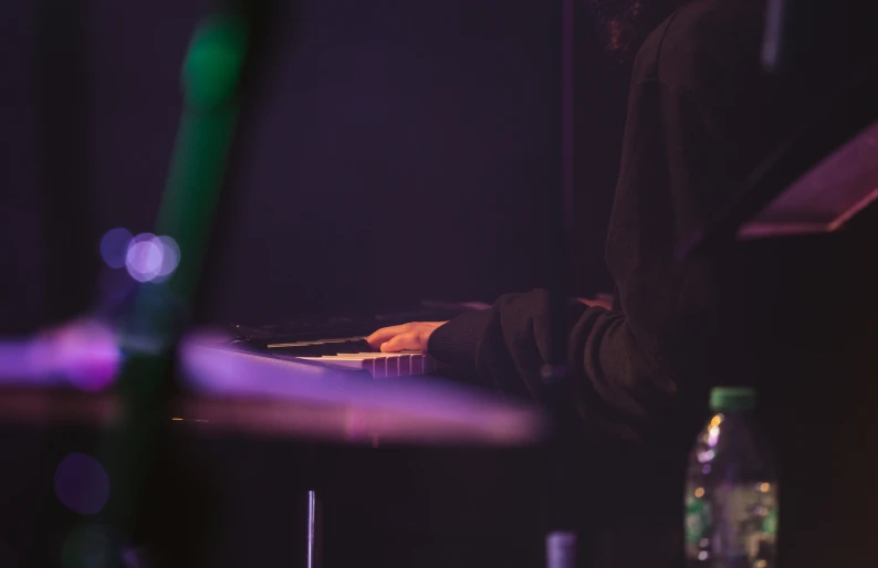 the person is playing a music instrument in the dark