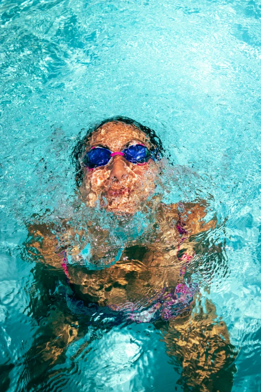 a person floating in the water near a swimming board