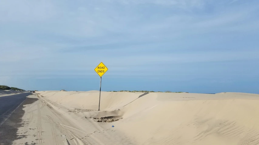 a road with a caution sign in the middle of it