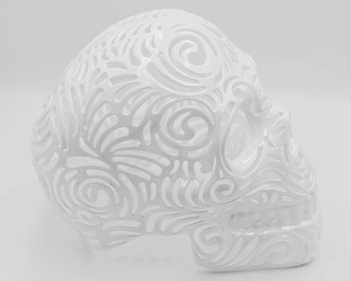 the carved skull has a wavy design and filigree