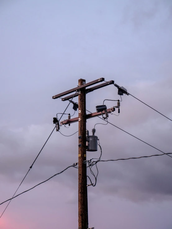 the power lines are suspended on a pole