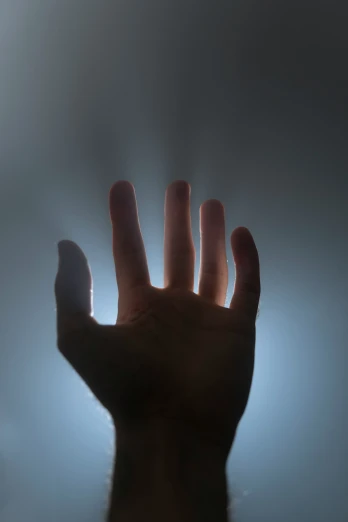 a blurry image of the hand extended in front of the camera