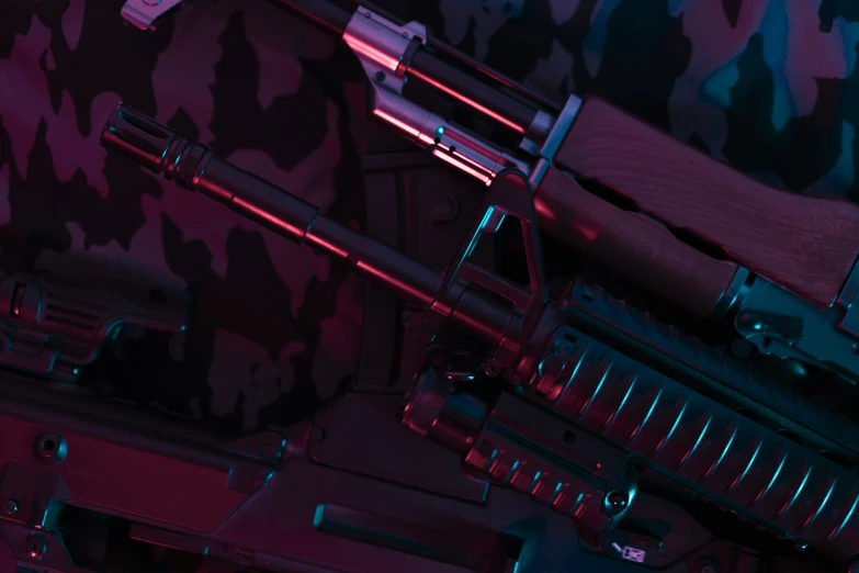 some guns in the dark in front of a camouflage wall