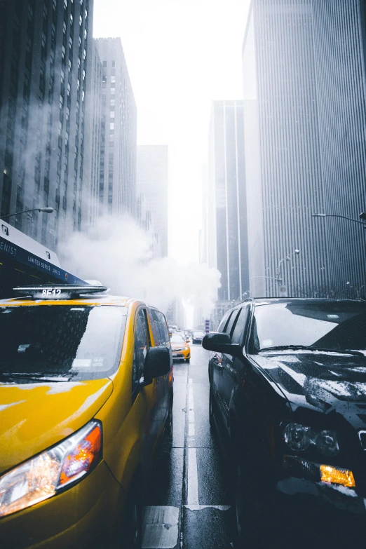 a yellow car is driving down a street