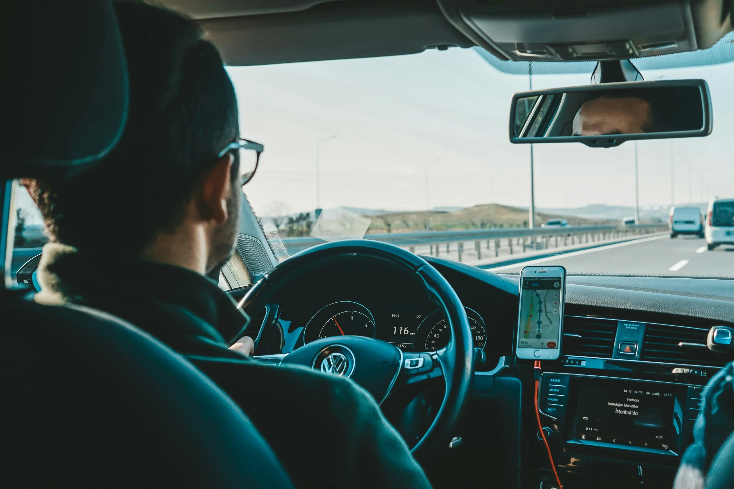 a man that is in the passenger seat of a car