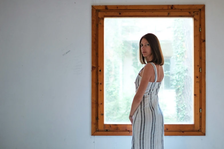 a woman standing in front of an open window