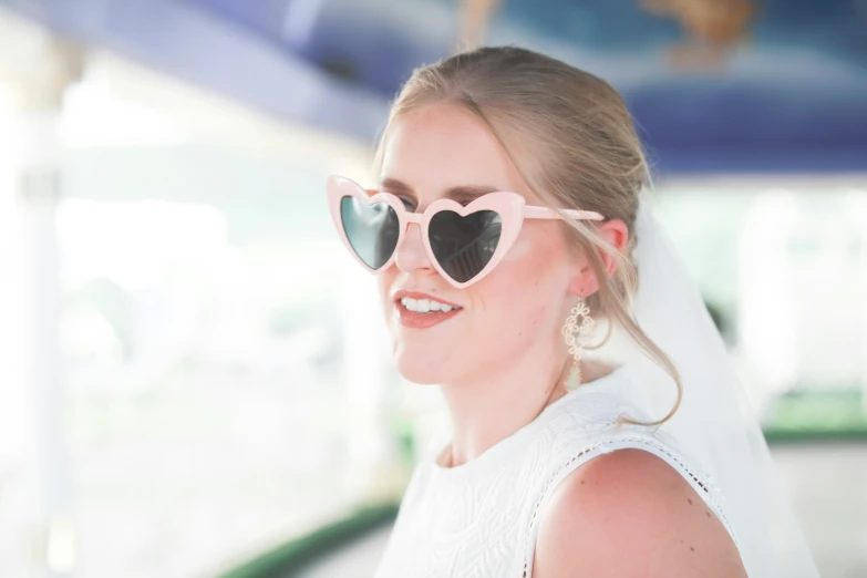 a woman wearing sunglasses that have hearts on them